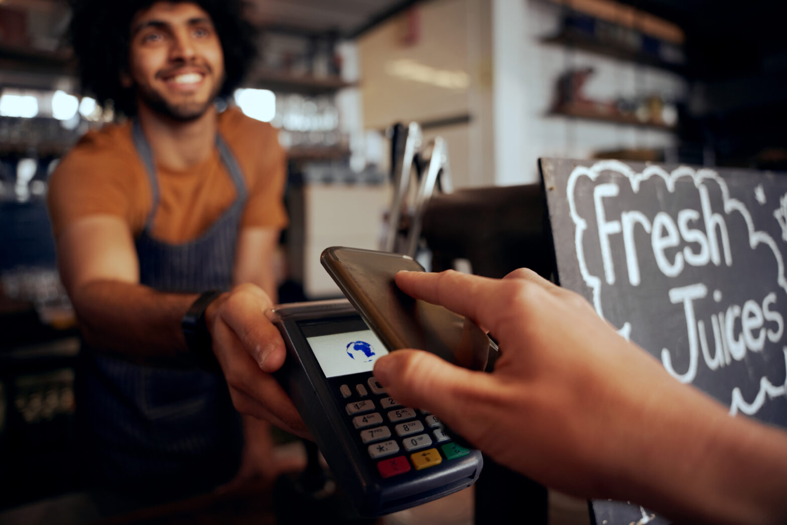 UK small business owner accepting contactless card payment with Lopay